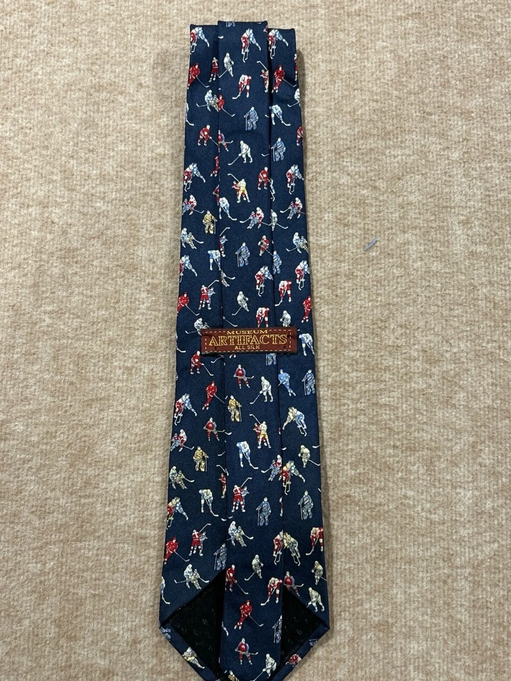 Museum Artifacts Silk Tie with Red, Cream, Blue and Gray Hockey Player Motif